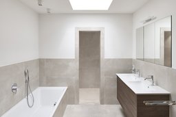 Modernes Badezimmer mit Oberlicht, schwebendem Holzwaschtisch, Einbauwanne und offener Duschnische